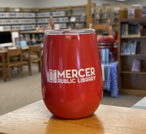 Red insulated tumbler with clear plastic lid and "Mercer Public Library" printed on the side.